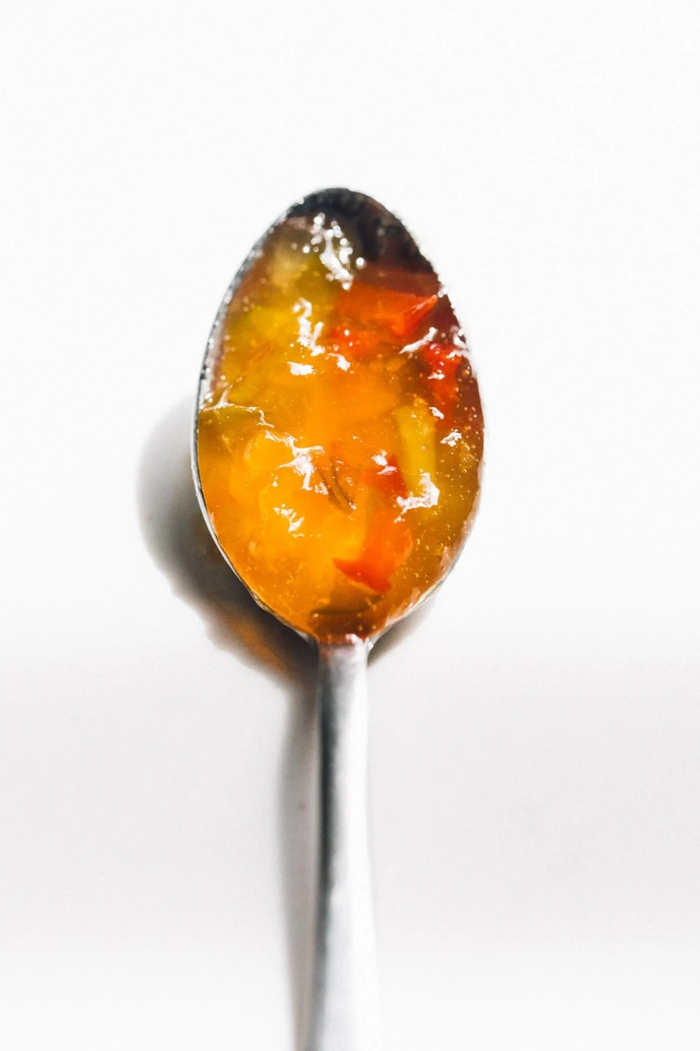 hot pepper jelly on a silver spoon