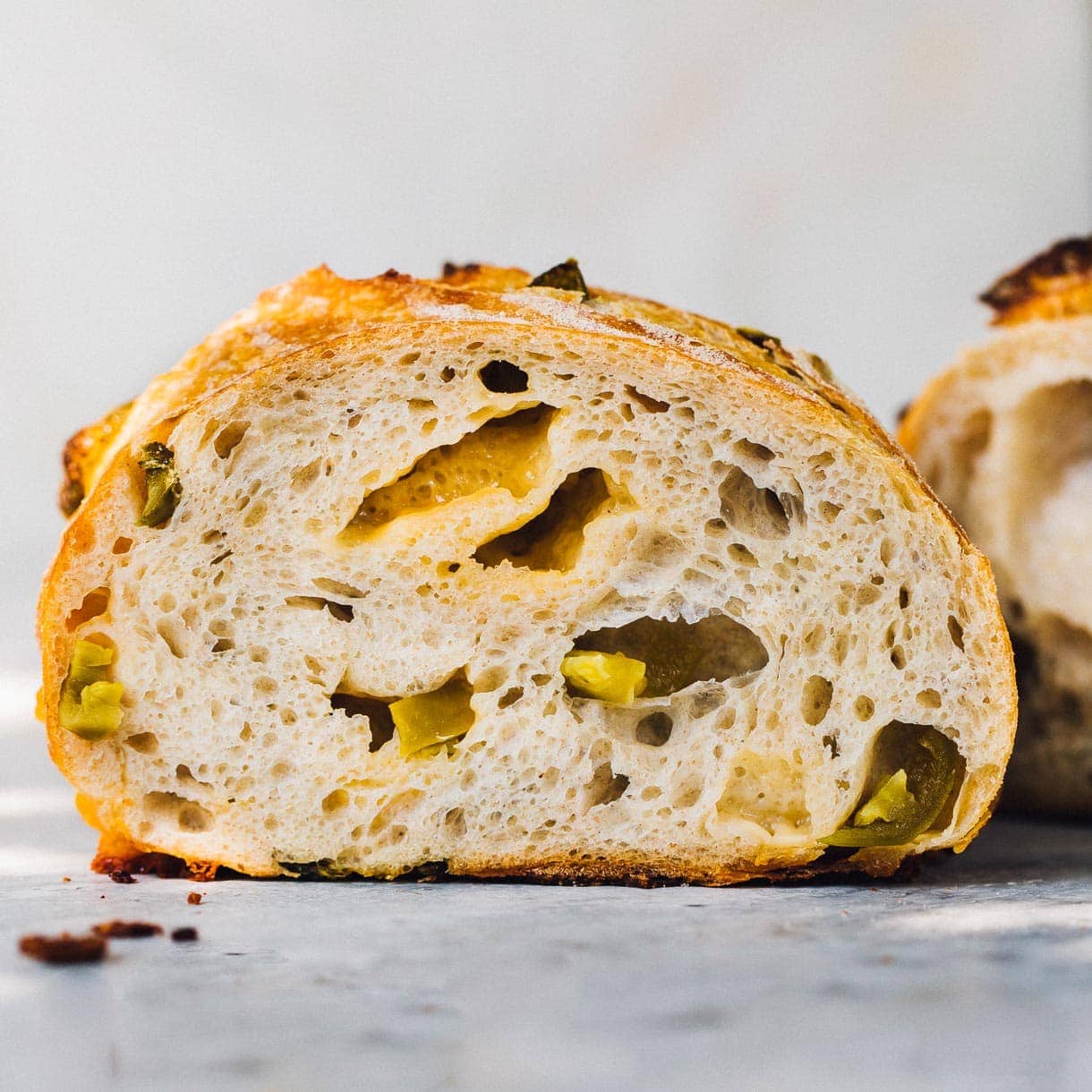 jalapeno cheddar sourdough bread, cut in half so crumb is facing camera