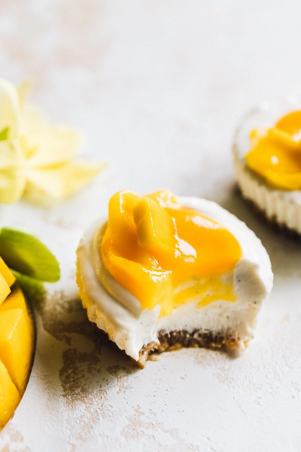 mango cheesecake mini, with a bite taken out of it