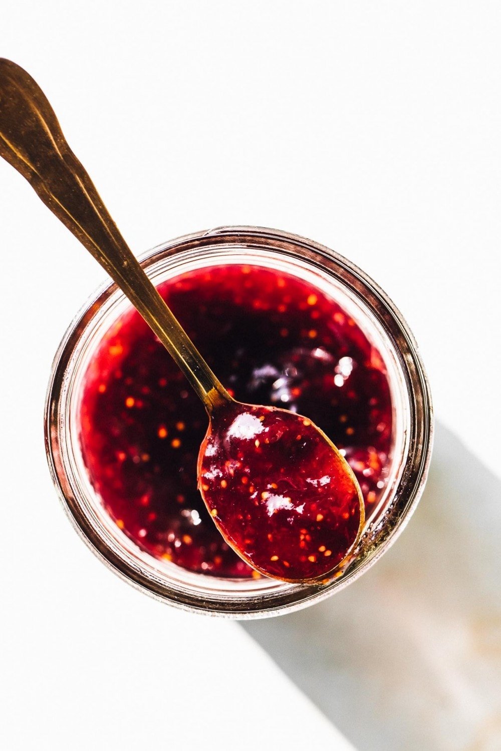 jar of fig jam with spoonful of jam on top of the jar