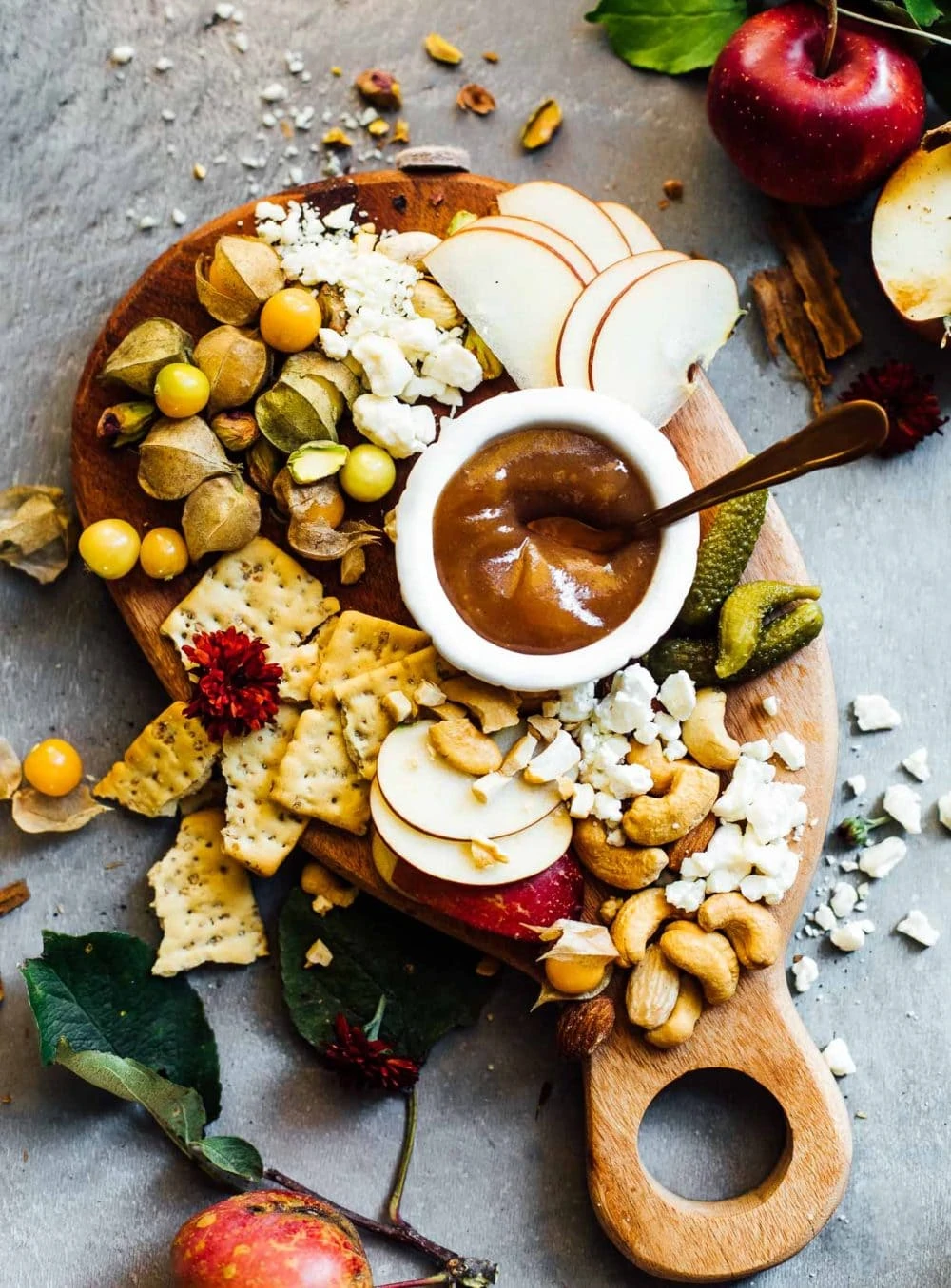 fall cheese board with apple butter, ground cherries, crackers, blue cheese, cashews