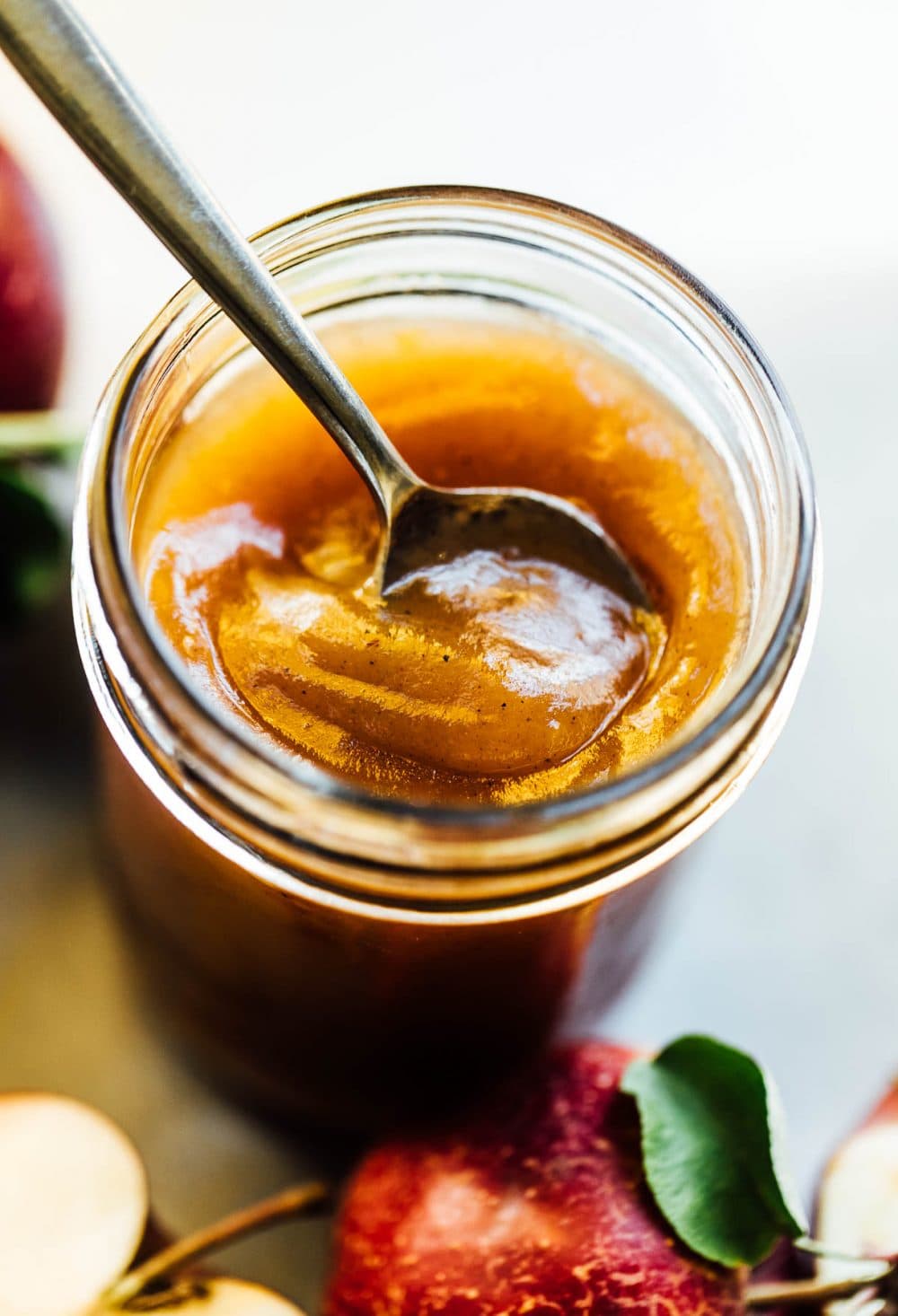 apple butter in a clear ball jar with spoon it