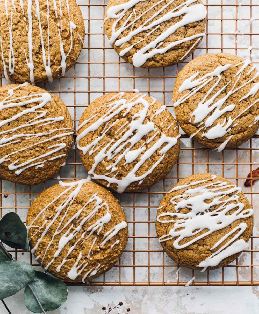 pumpkin cookies on cooling rack with icing