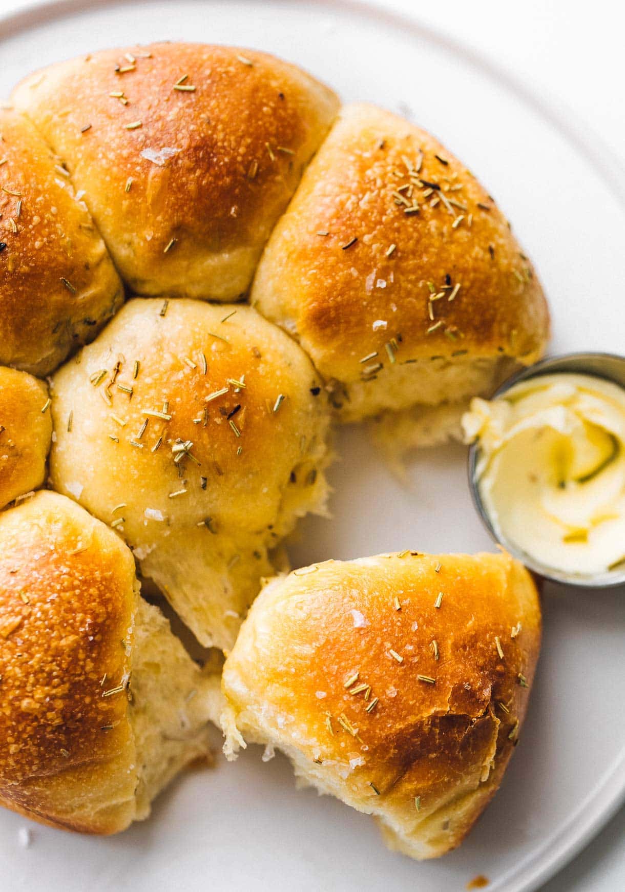 sourdough dinner rolls on a plate with butter