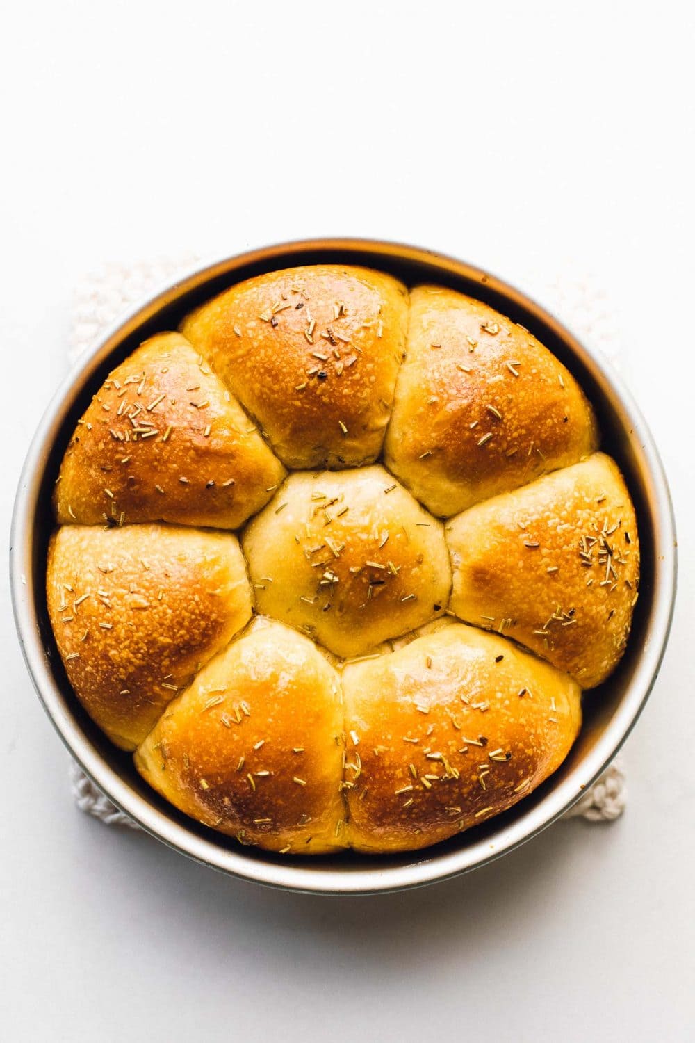 soft and fluffy sourdough dinner rolls in a pan