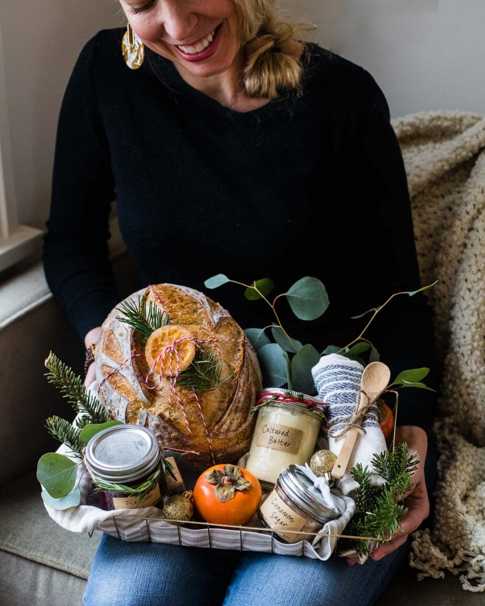 Woman Baker With A Basket Of Bread Ingredients And Baking Supplies