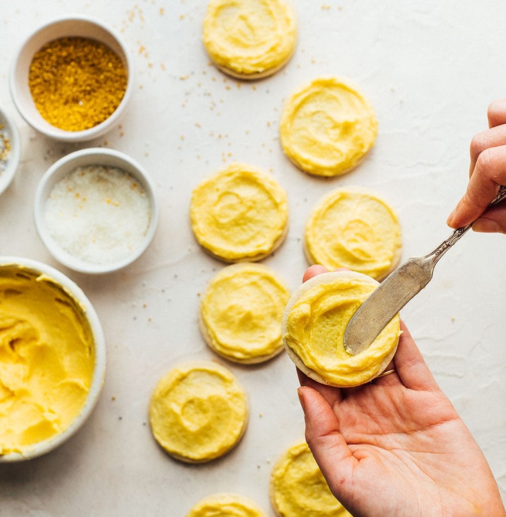 frosting sugar cookies with mango buttercream