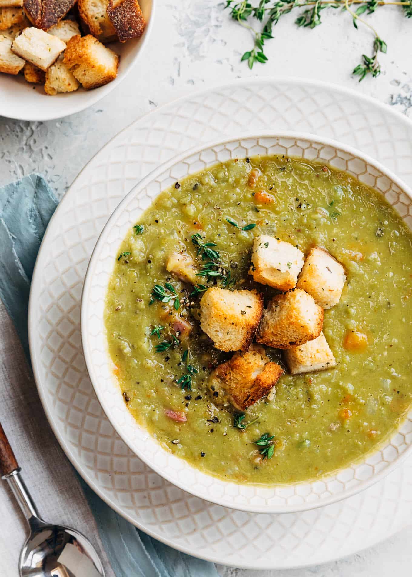 split pea soup with croutons in white bowl