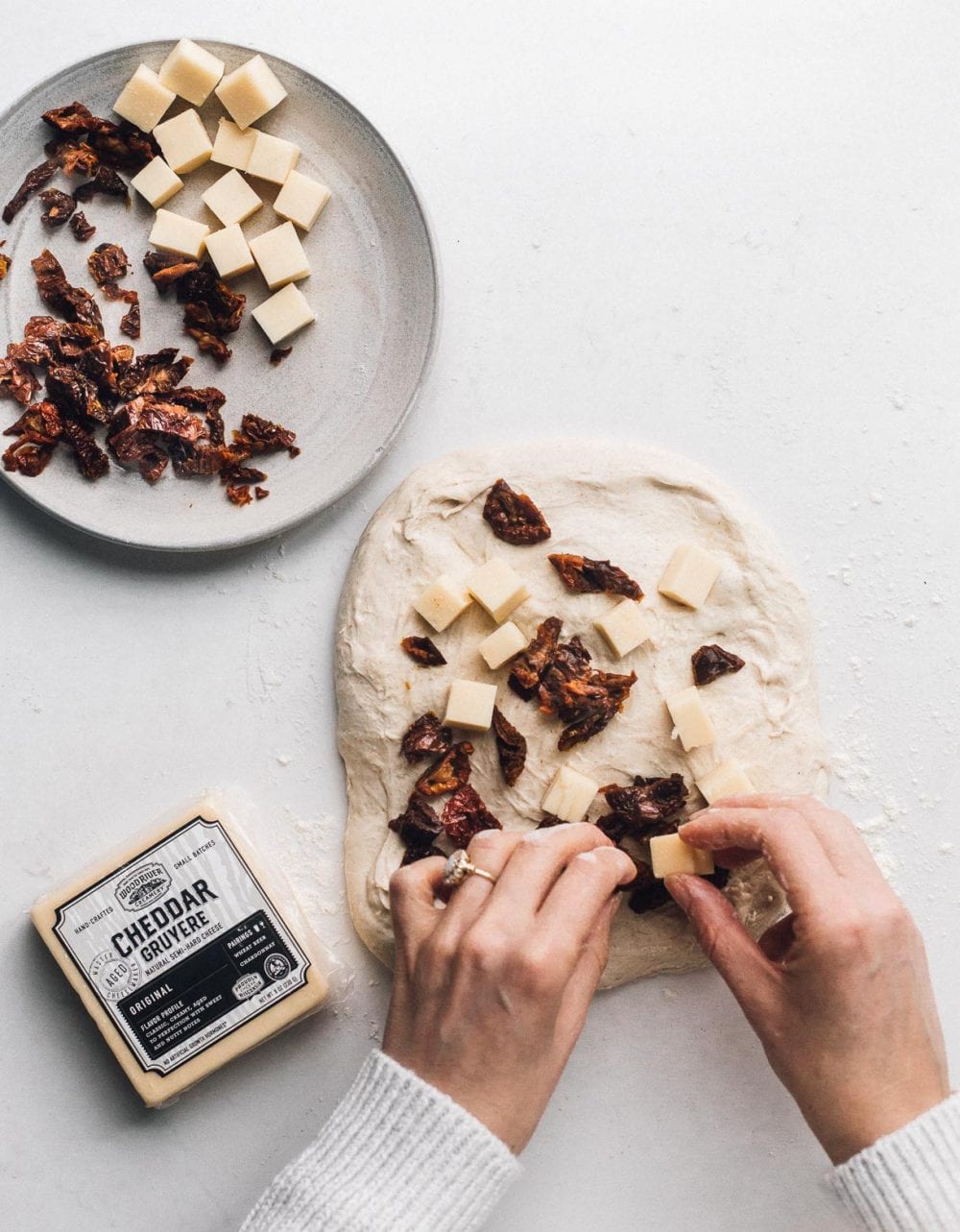 adding cheese and sun-dried tomatoes to sourdough