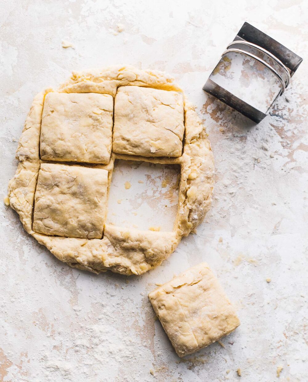 cutting out biscuits with a square biscuit cutter