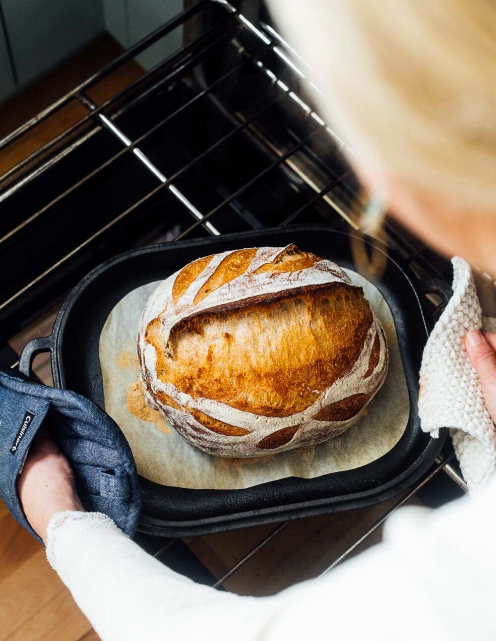 baking sourdough in a challenger bread, pulling it out of the oven