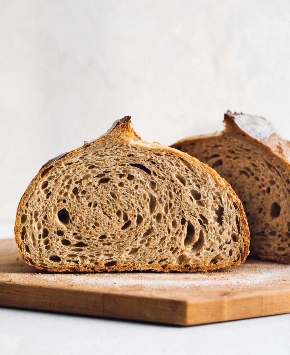 whole wheat sourdough bread, cut in half with crumb showing