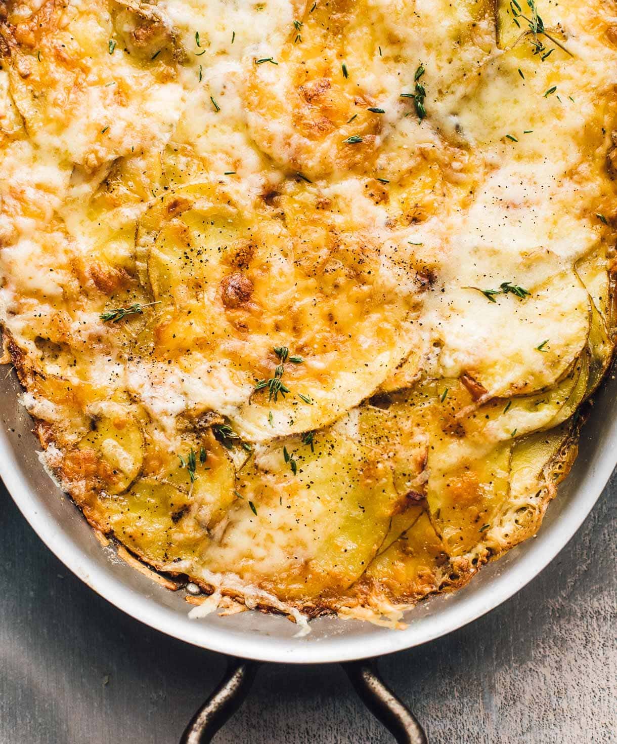 au gratin potatoes in an oval metal pan