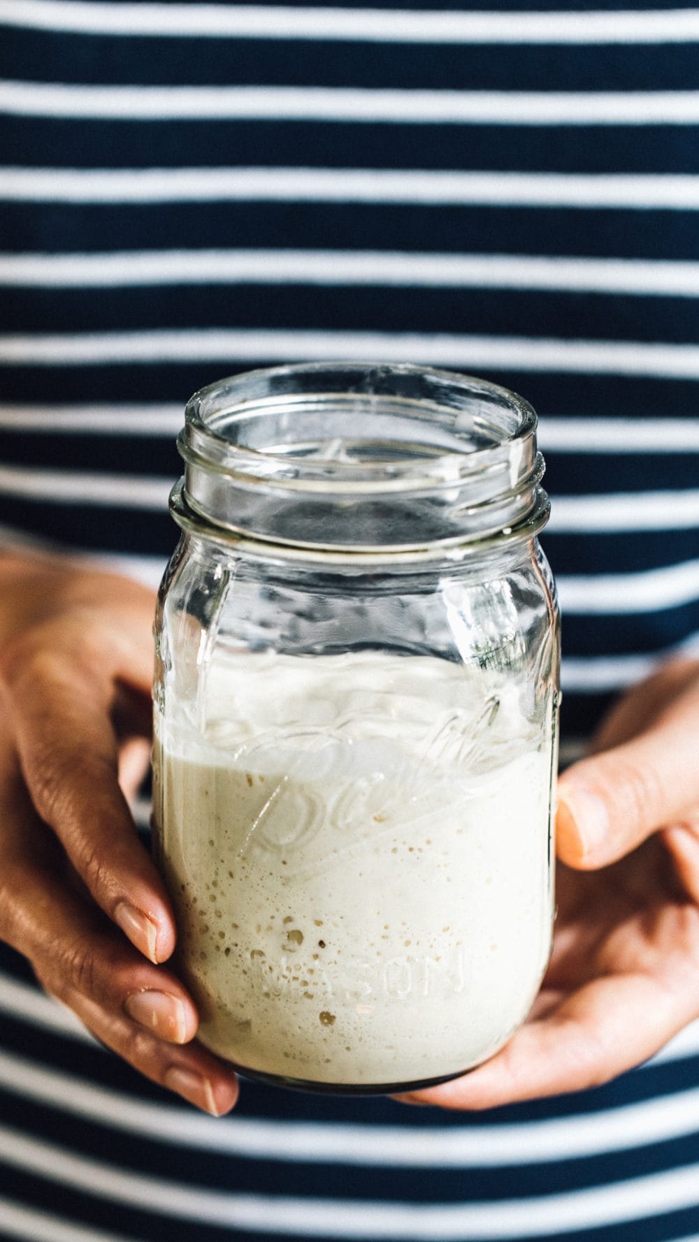 holding sourdough starter in hands