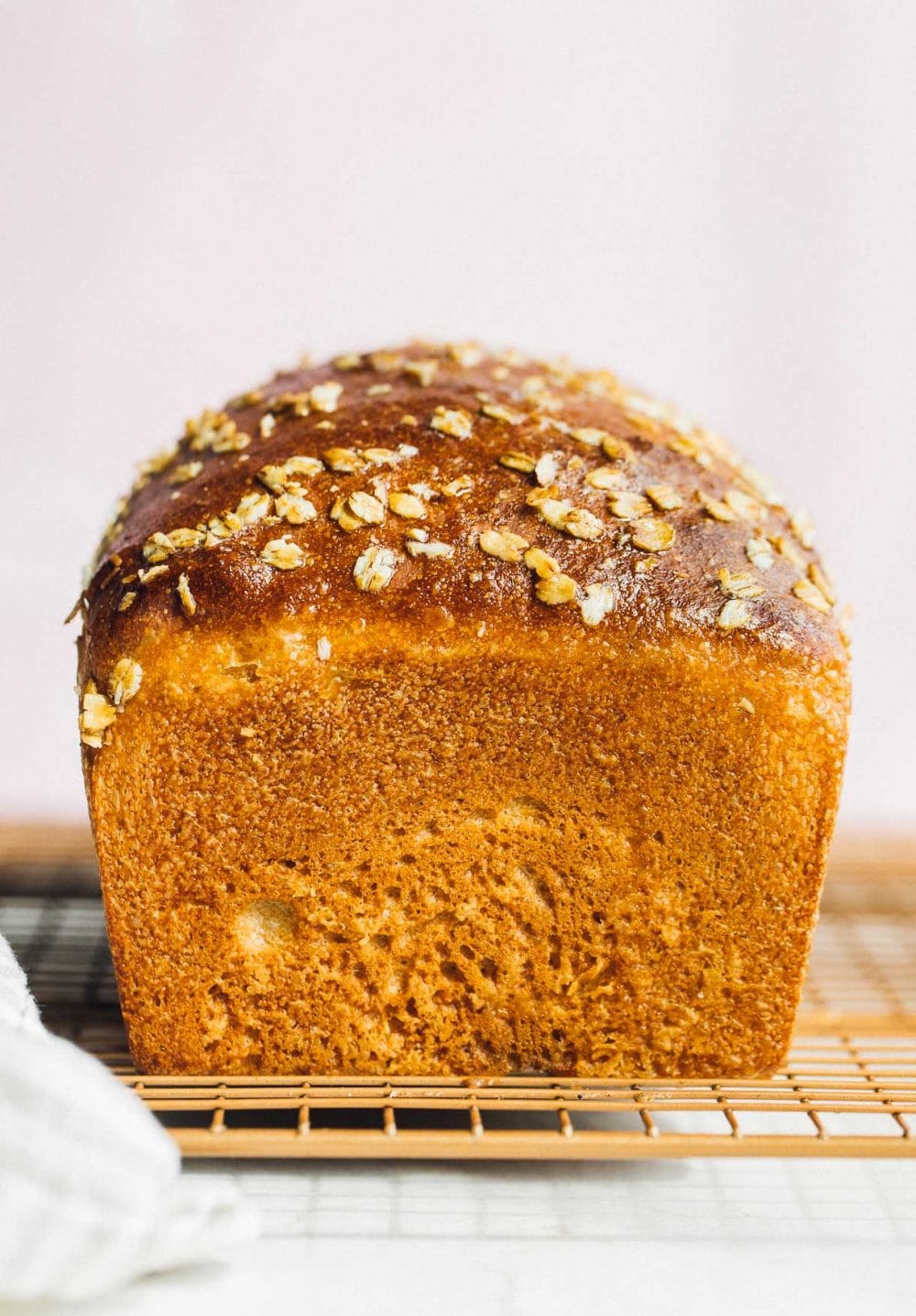 whole wheat sourdough sandwich bread on a copper cooling rack