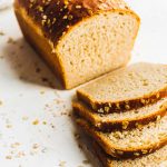 sliced whole wheat sourdough sandwich bread on white board