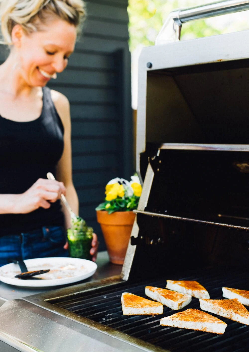 woman with blond hair grilling tofu