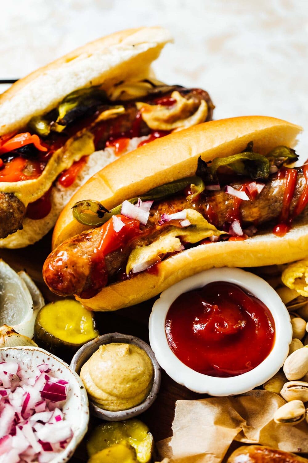 Grilled Brats in Buns with ketchup and mustard nearby