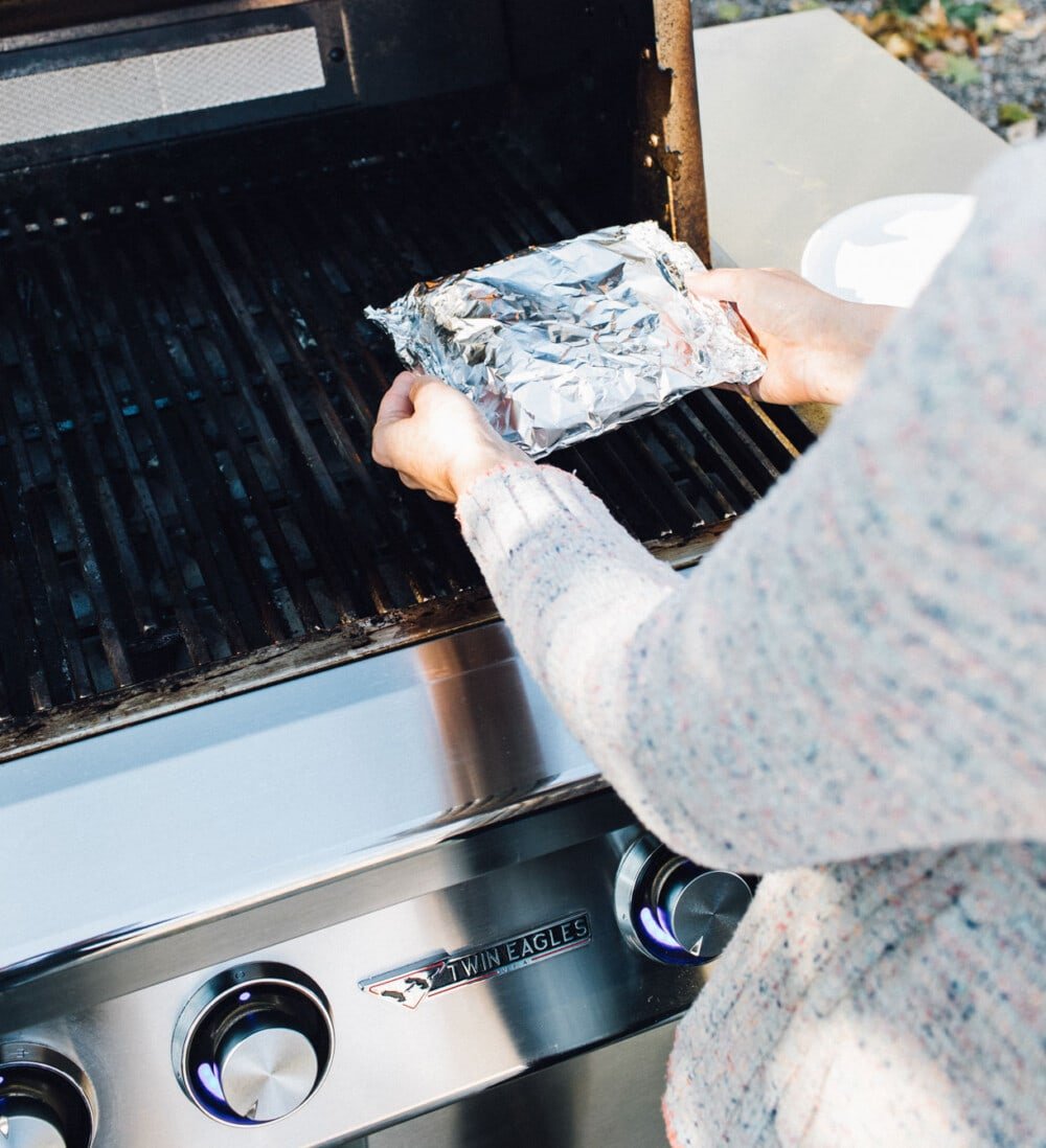 placing a foil pack on the grill