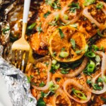 spicy grilled salmon cooked in foil, with fork.
