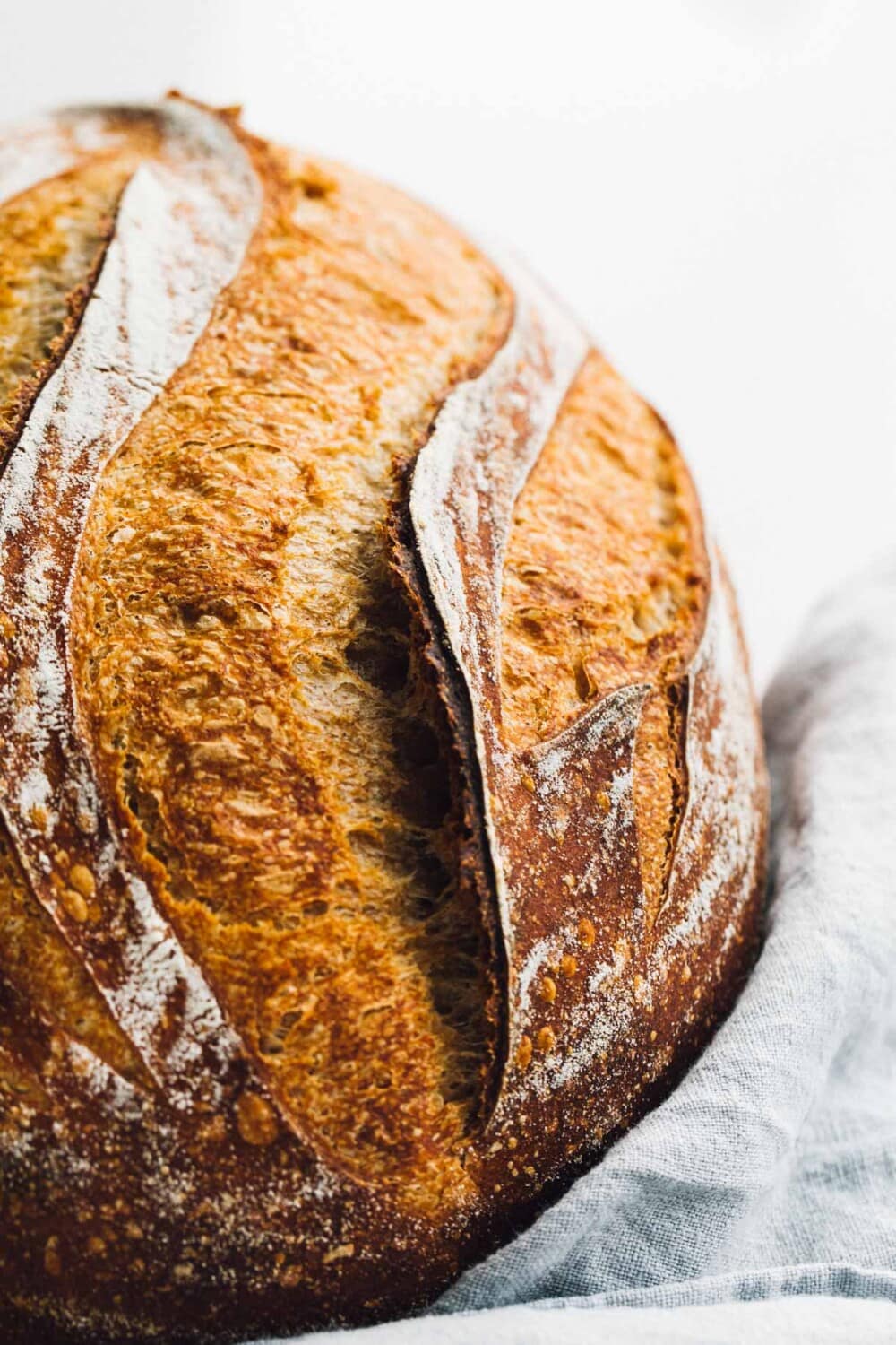 spelt sourdough bread loaf with blue linen