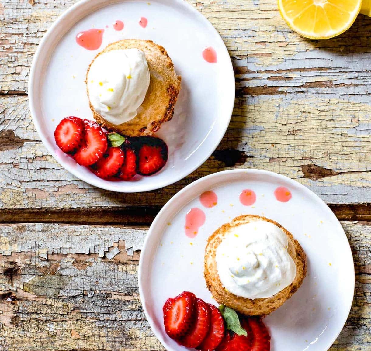 gluten-free angel food cakes on white plates with strawberries