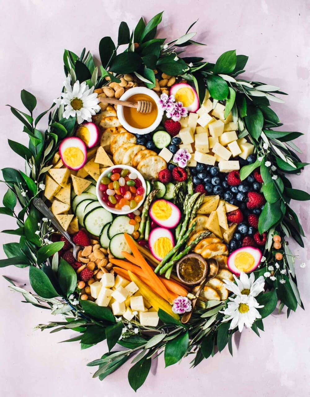 easter charcuterie board with greens and flowers