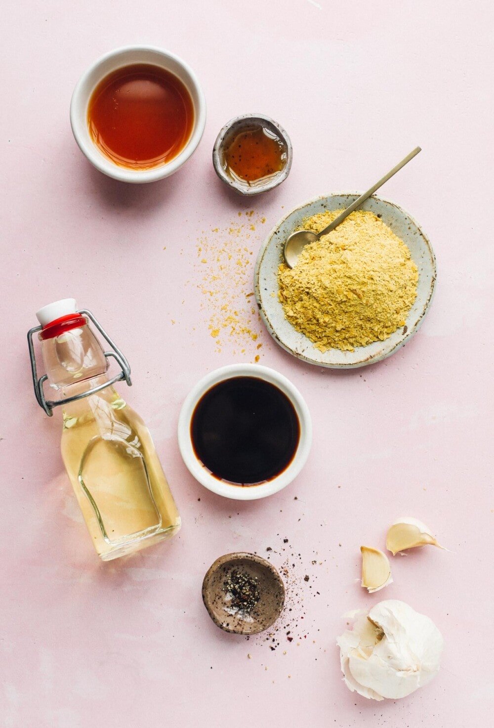 easy vegan salad dressing ingredients on a pink backround