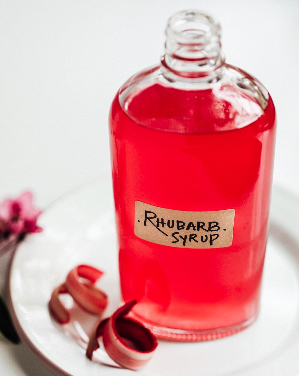 rhubarb simple syrup in glass bottle with label on it