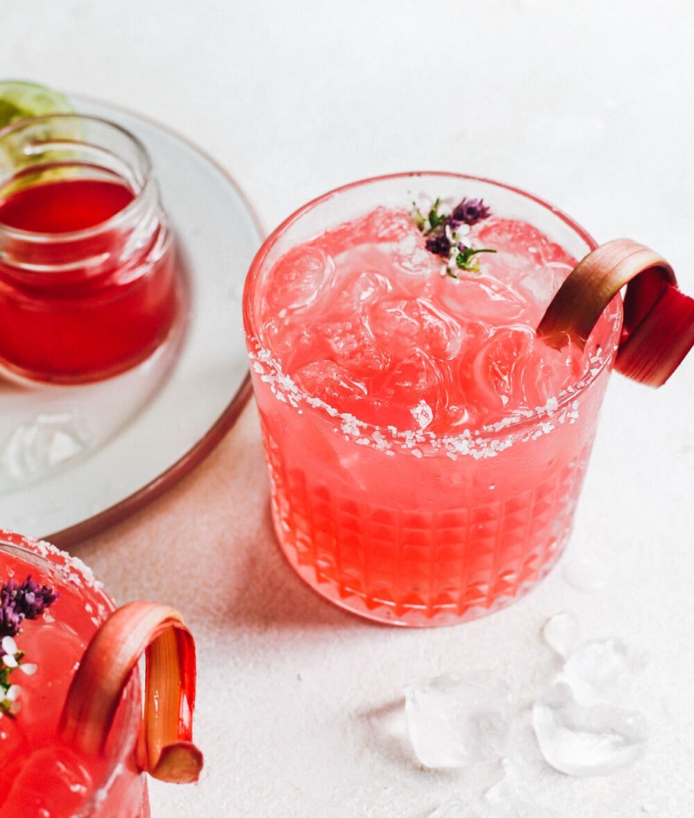 rhubarb margarita sitting by rhubarb simple syrup