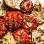 grilled tomatoes on white plate with sourdough bread