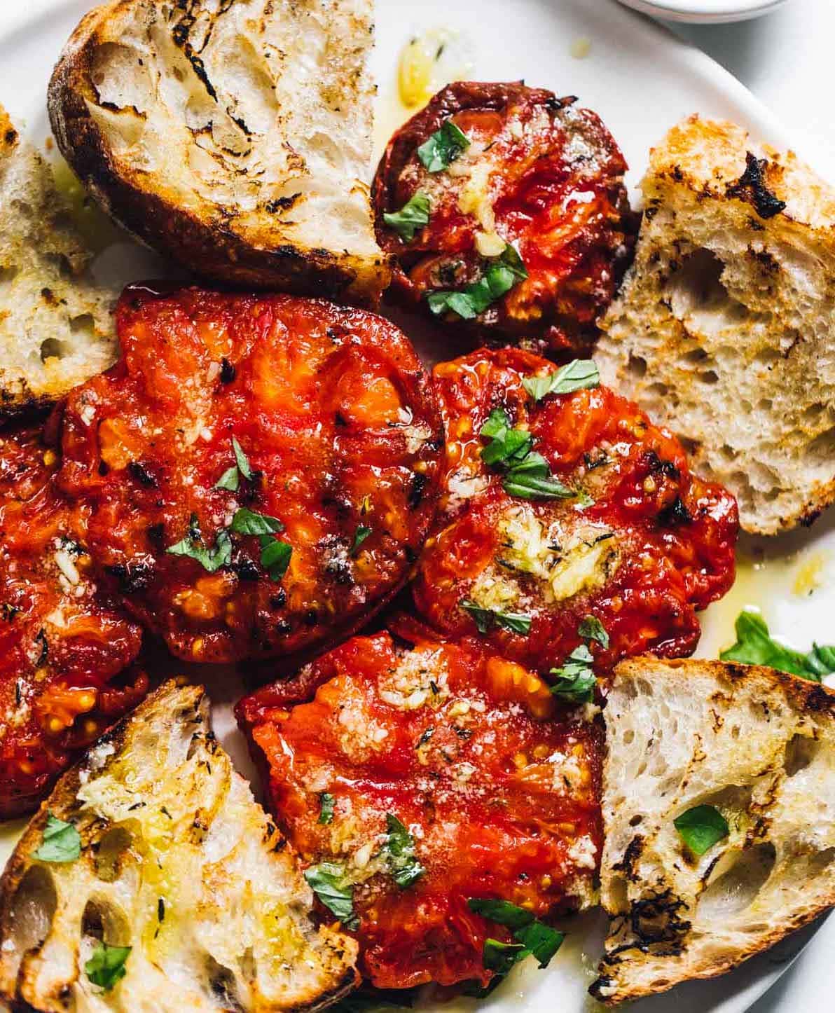 grilled tomatoes on white plate with sourdough bread
