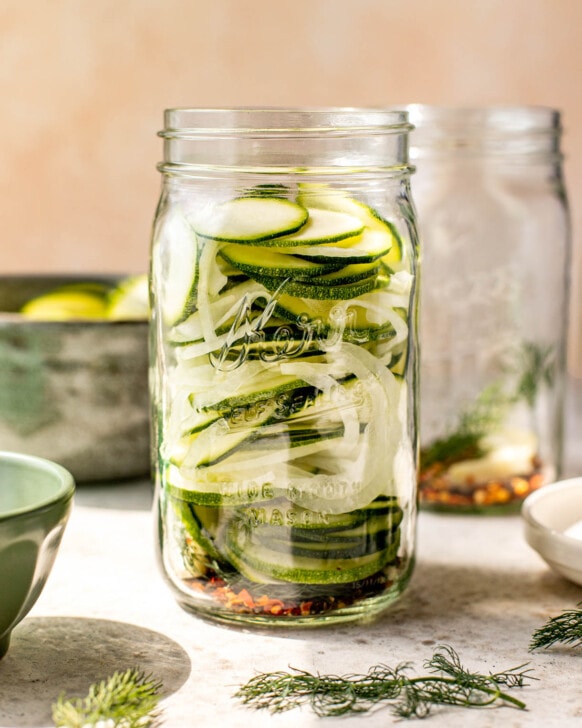 zucchini and onion layered in a glass jar