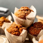 gluten-free pumpkin muffins stacked on one another