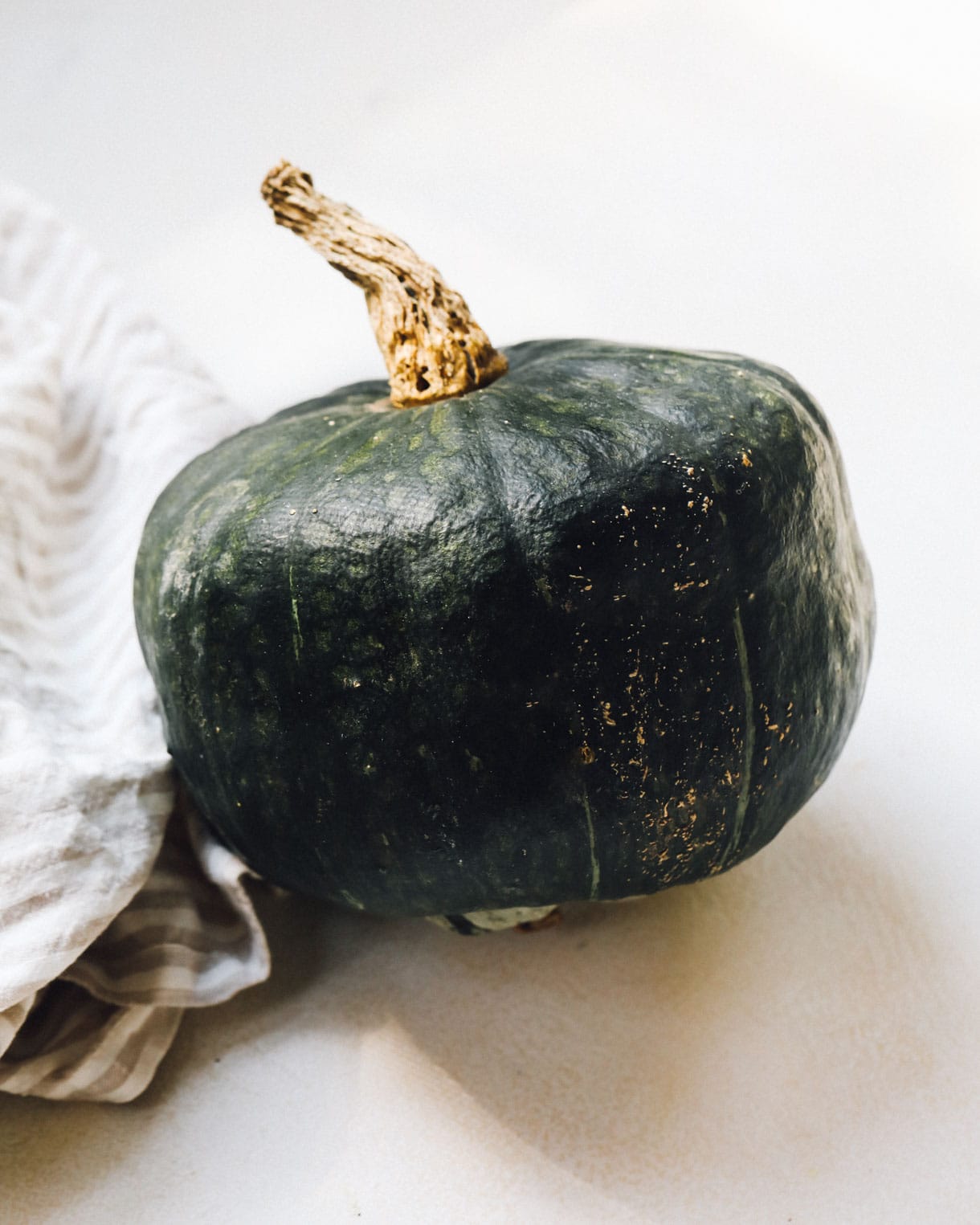 buttercup squash on white linen