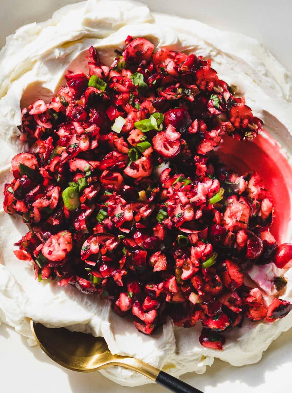 cranberry jalapeno cream cheese dip with a gold spoon