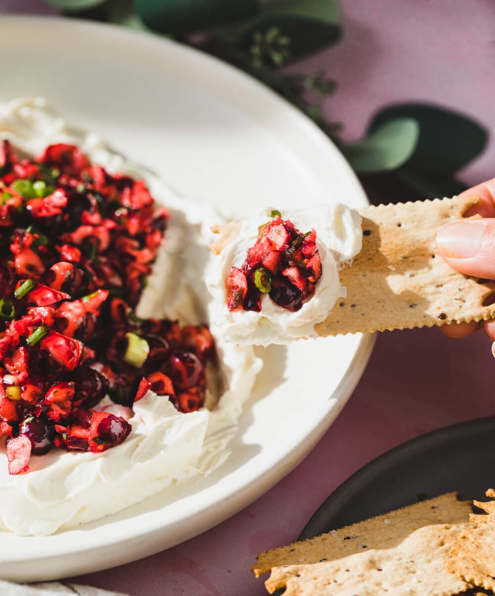 cranberry jalapeno cream cheese dip on a white plate