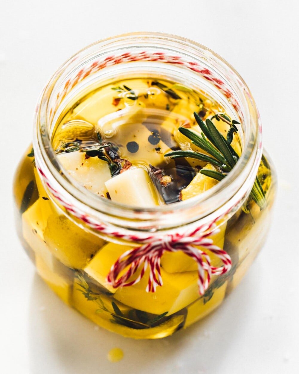 olive oil marinated cheese in a clear jar