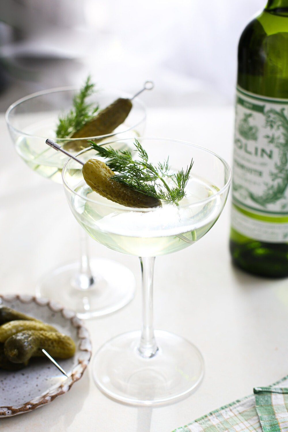 dill pickle martini in coupe glasses