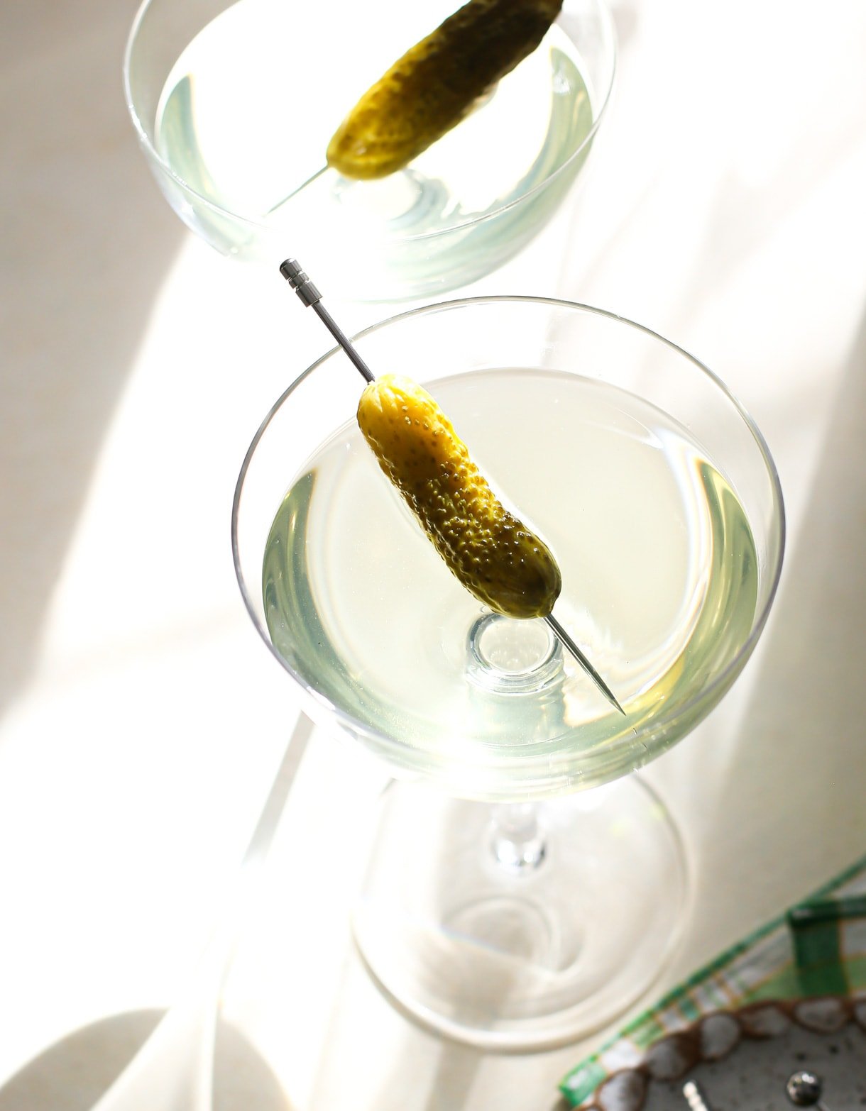 dill pickle martini in couple glass