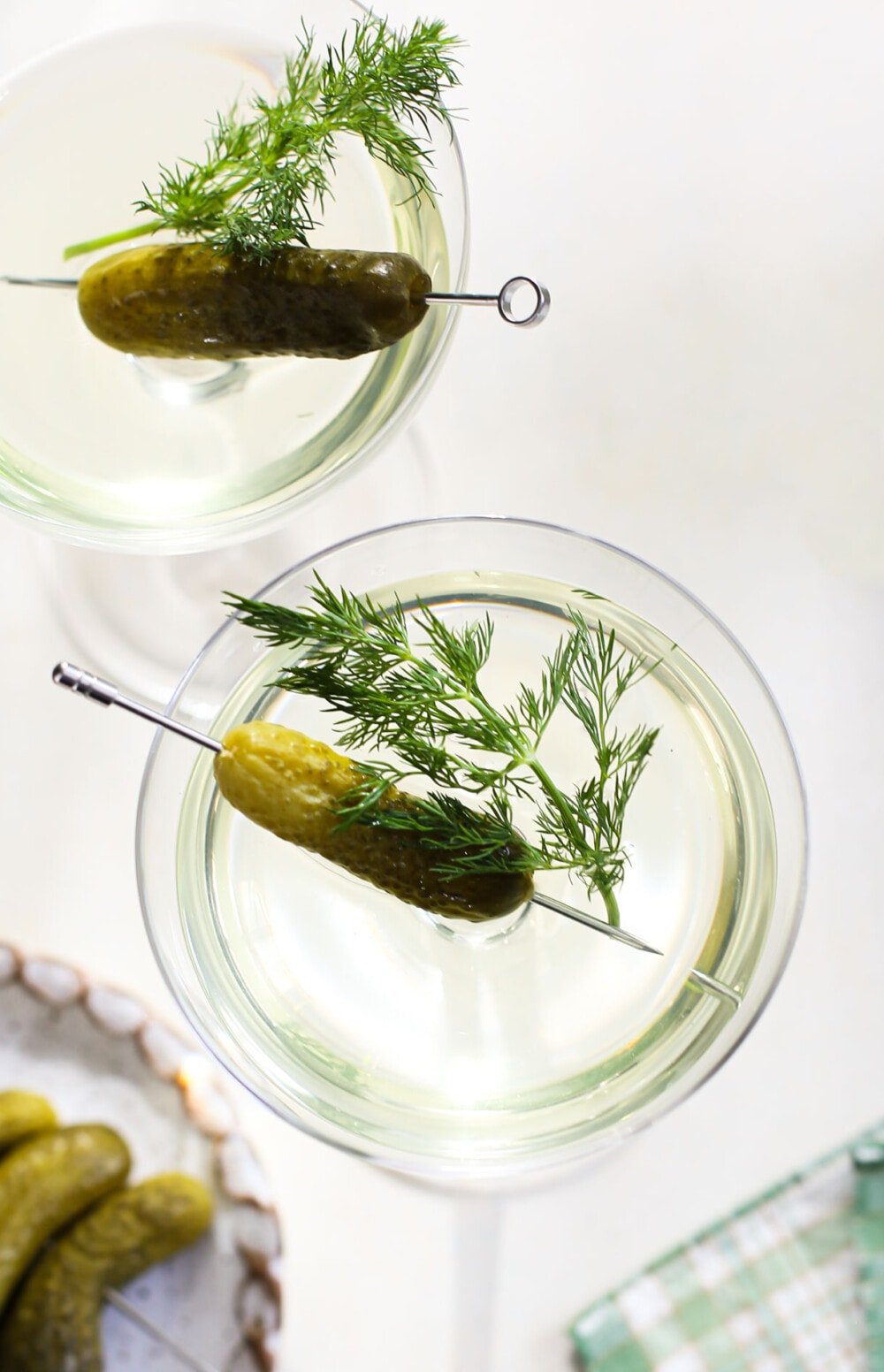 dill pickle martini in couple glass