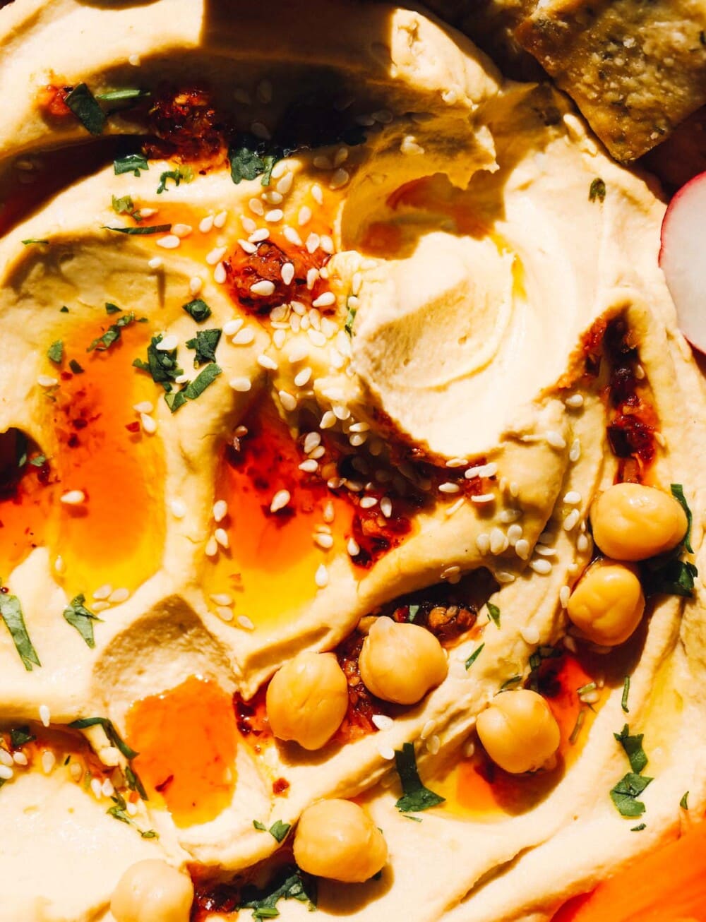 close up photo of spicy hummus with chickpeas