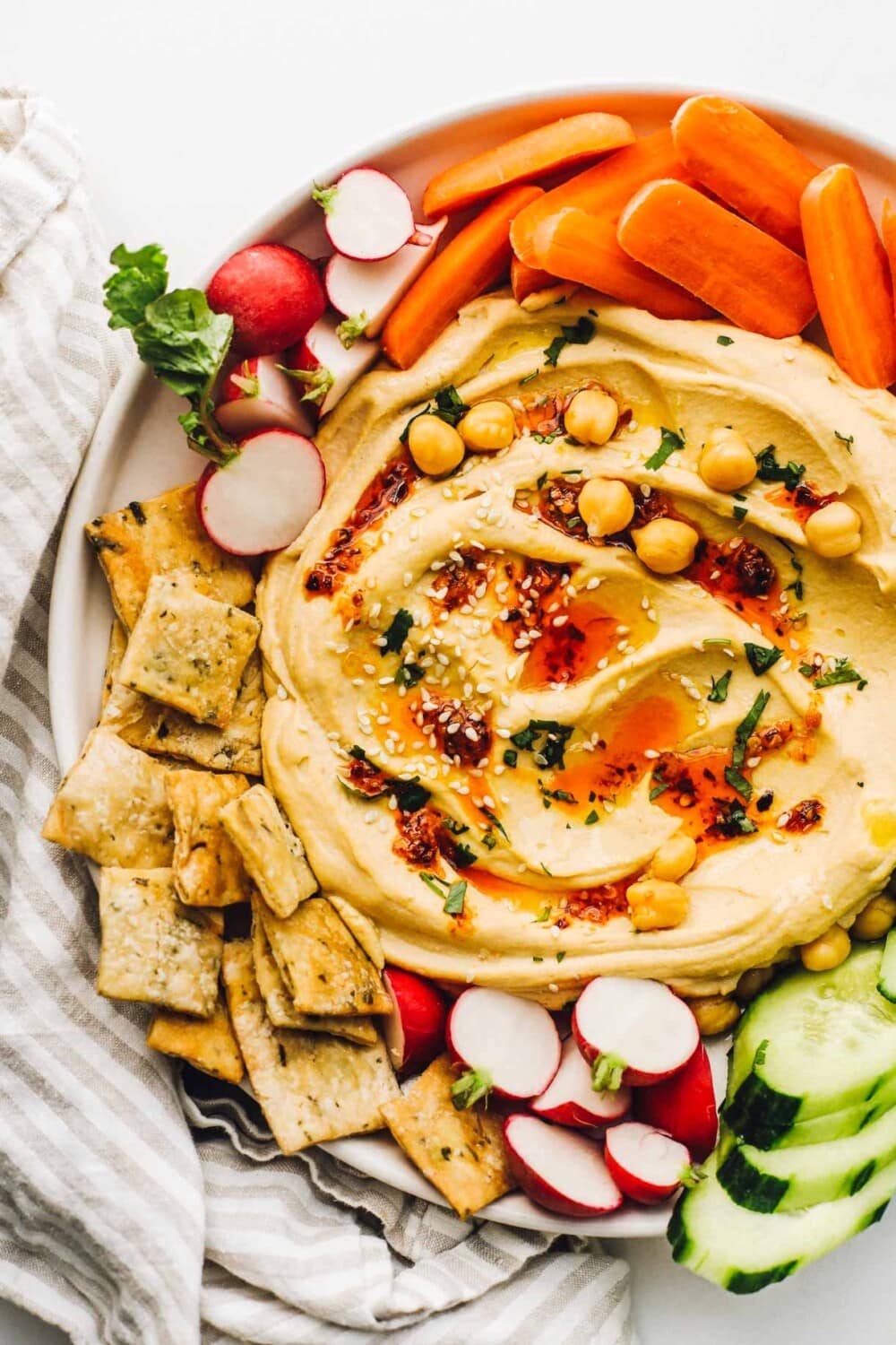 spicy hummus on a platter with vegetables