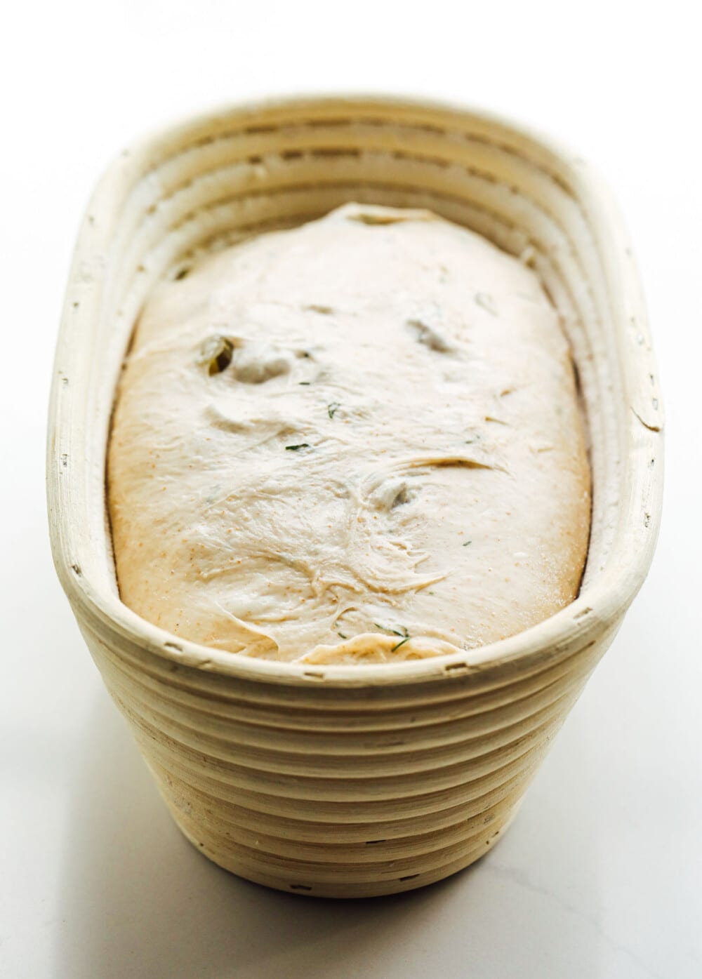 sourdough bread in oval banneton after finishing its final rise