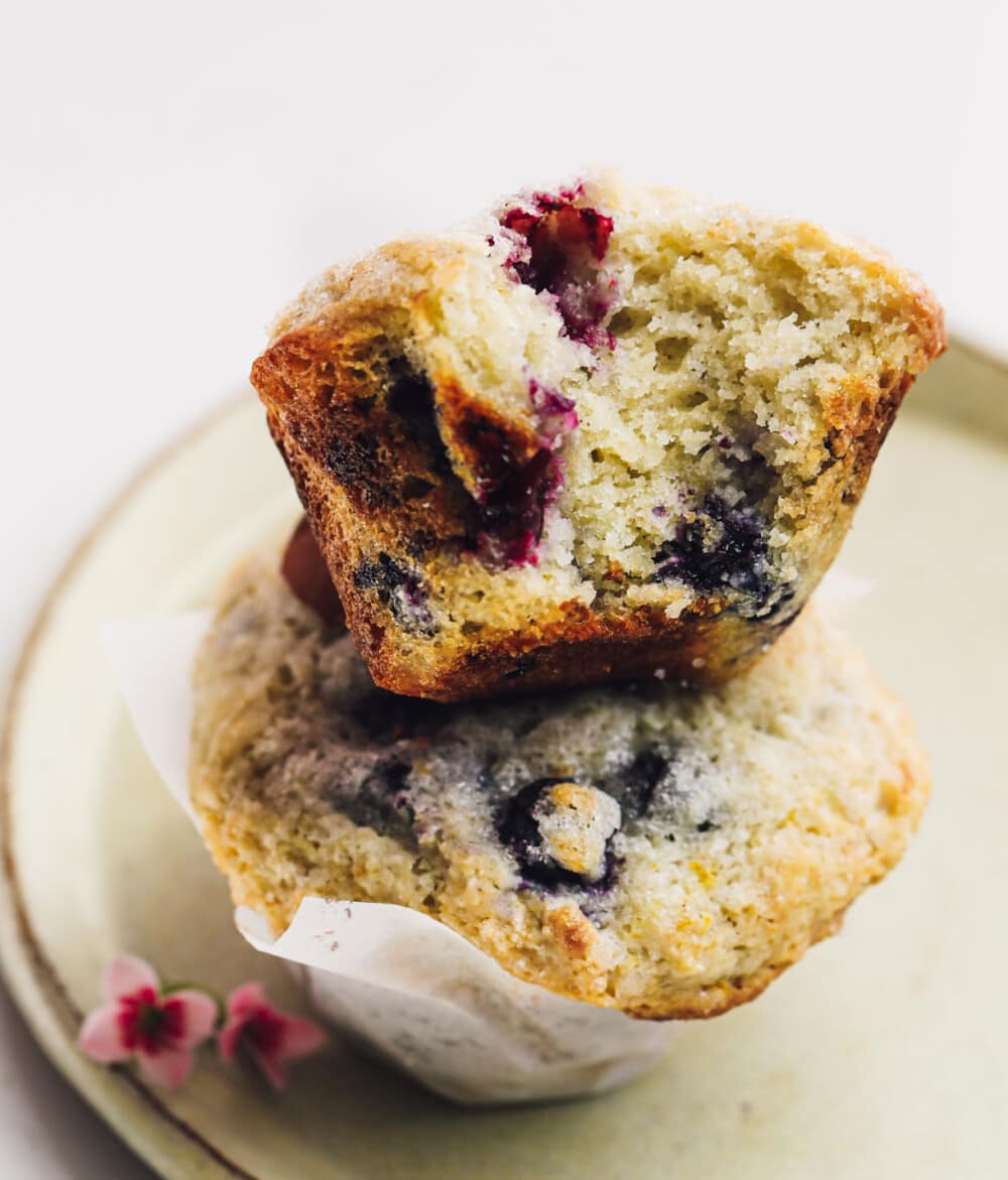 blueberry muffins stacked on yellow plate