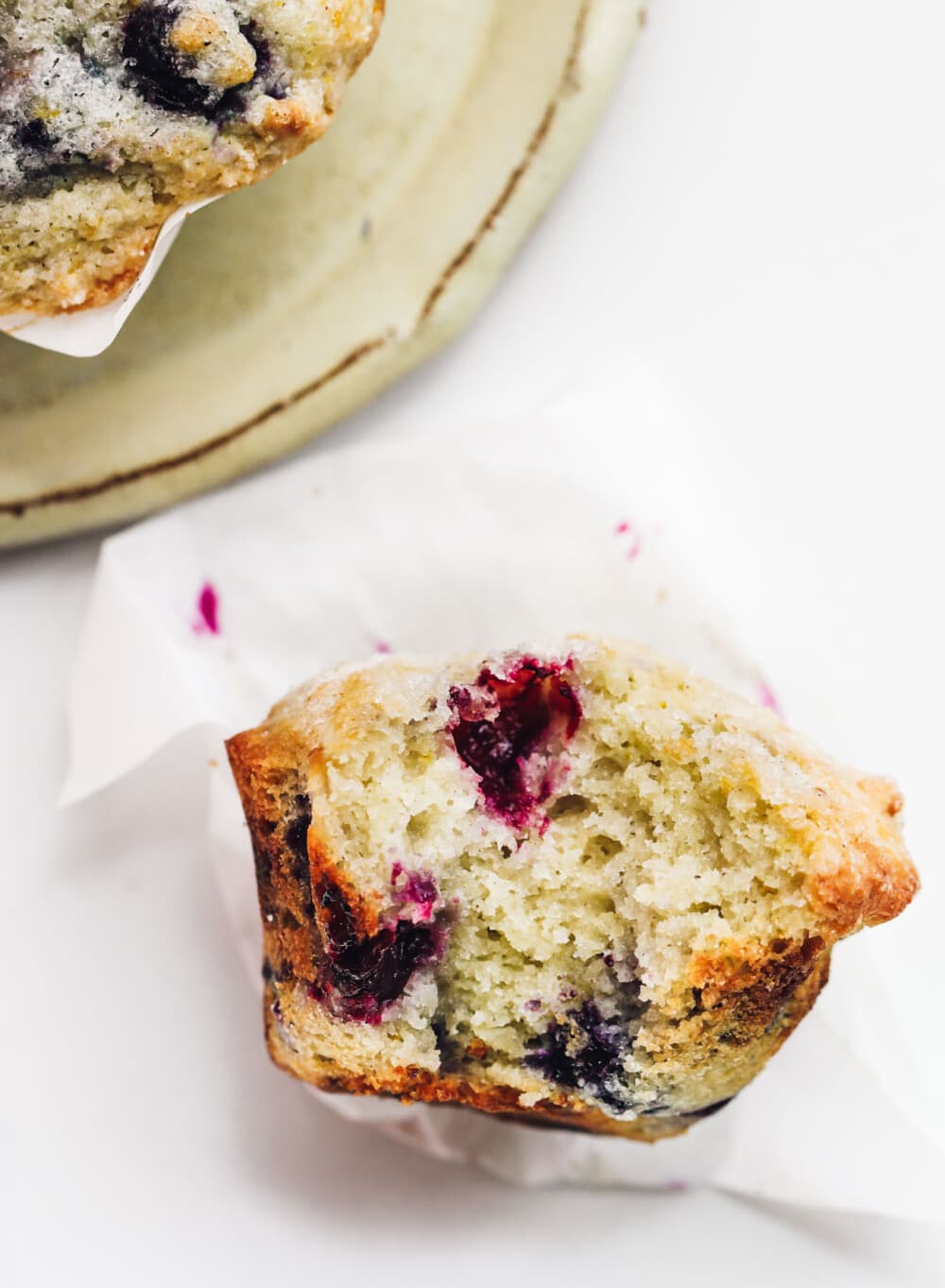 gluten-free blueberry muffin on white parchment paper