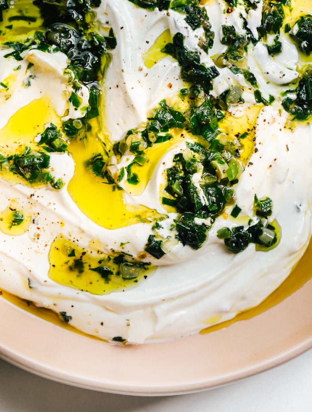 sour cream and ramp dip in a pink bowl