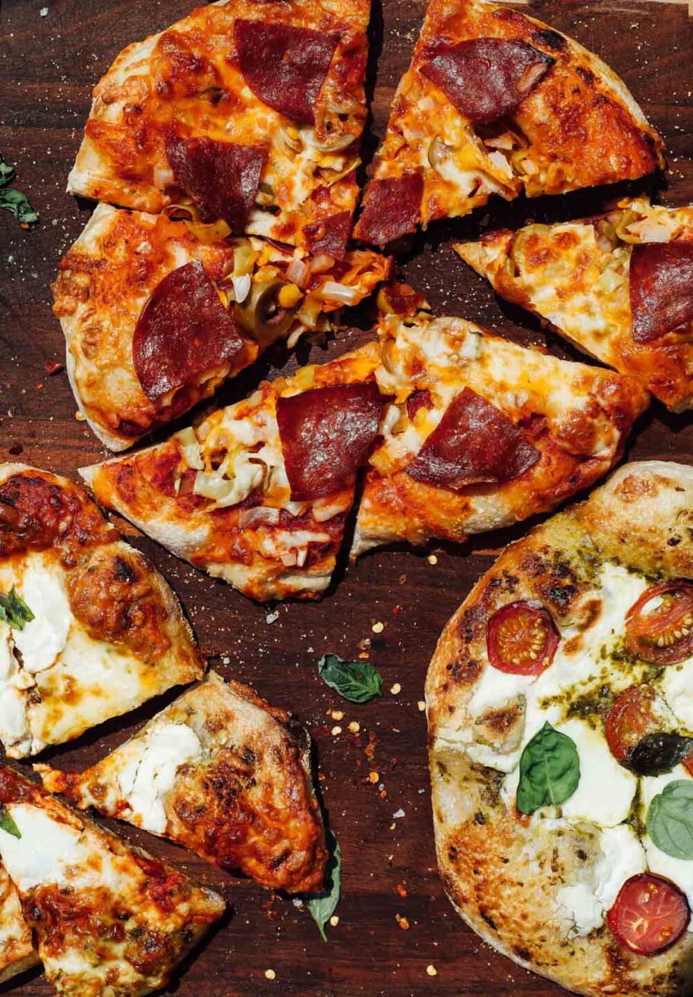 sourdough pizza cut into pieces on a wooden cutting board