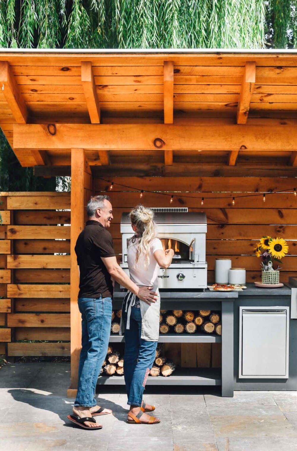 backyard outdoor kitchen with husband and wife