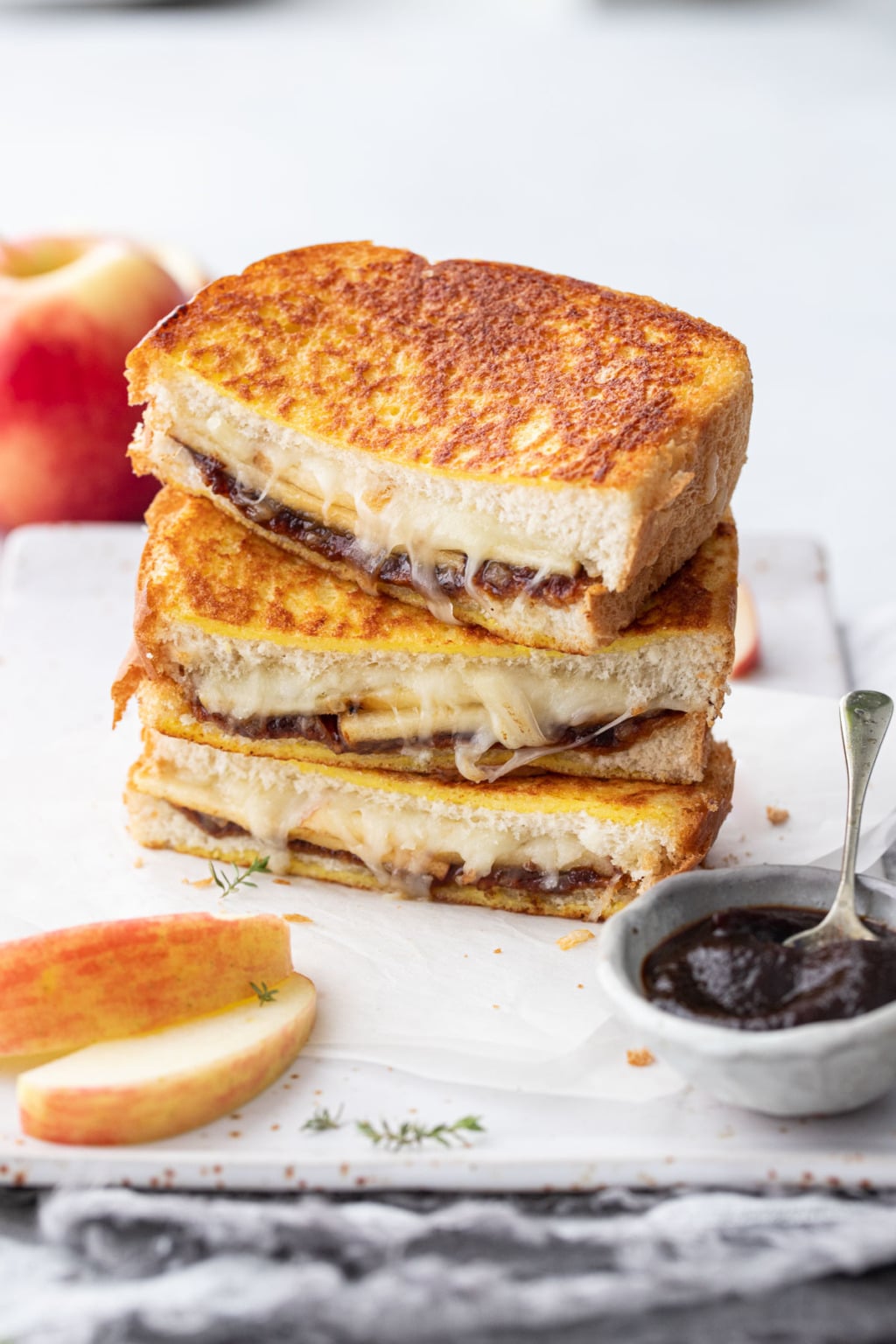 apple butter grilled cheese stacked on white board